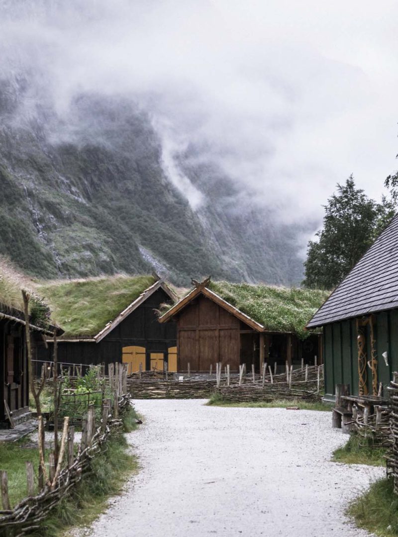 Gudvangen, Norway - a viking cottages in the clouds of Nærøyfjord, surrounded by mountains, waterfalls and narrow valleys. Traditional wooden houses showing the medieval life in the viking village.